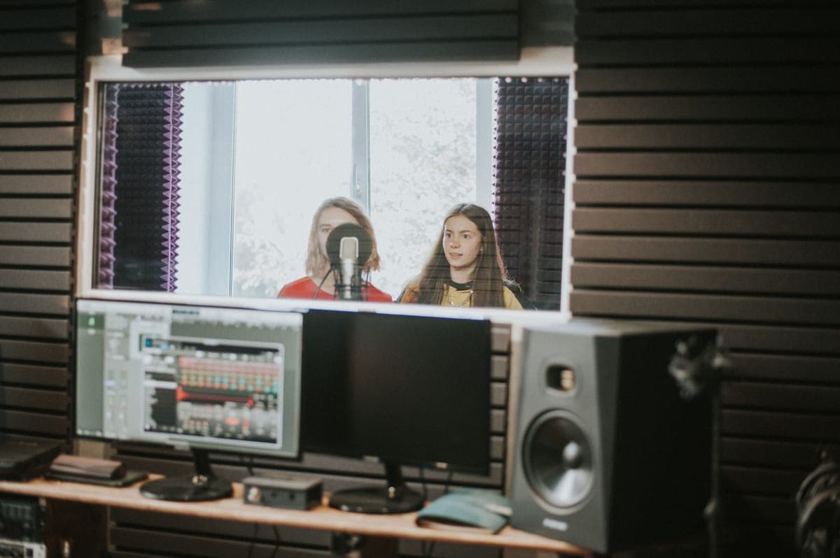 Fabric-wrapped acoustic absorption panels mounted on a studio wall