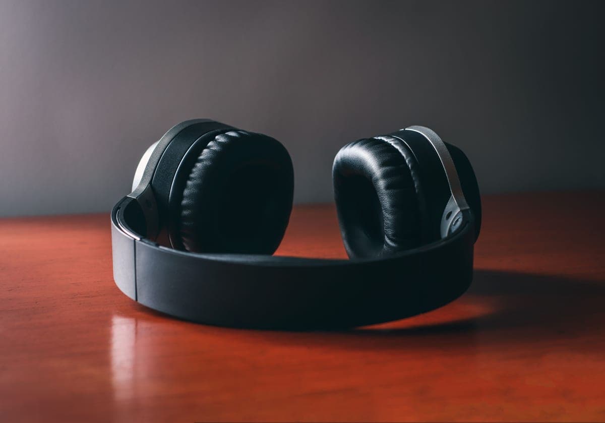 Over-ear studio headphones resting on a mixing desk