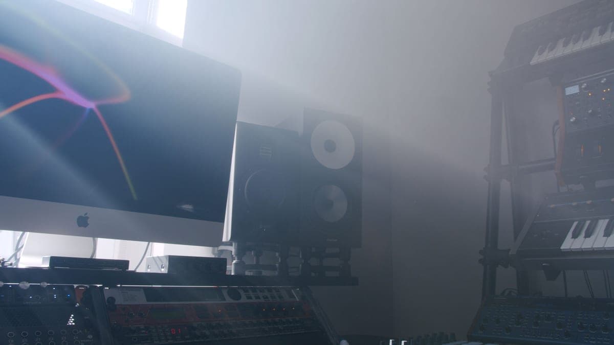 A pair of nearfield studio monitors either side of a mixing position